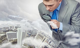 Businessman with magnifying glass on the world.jpeg